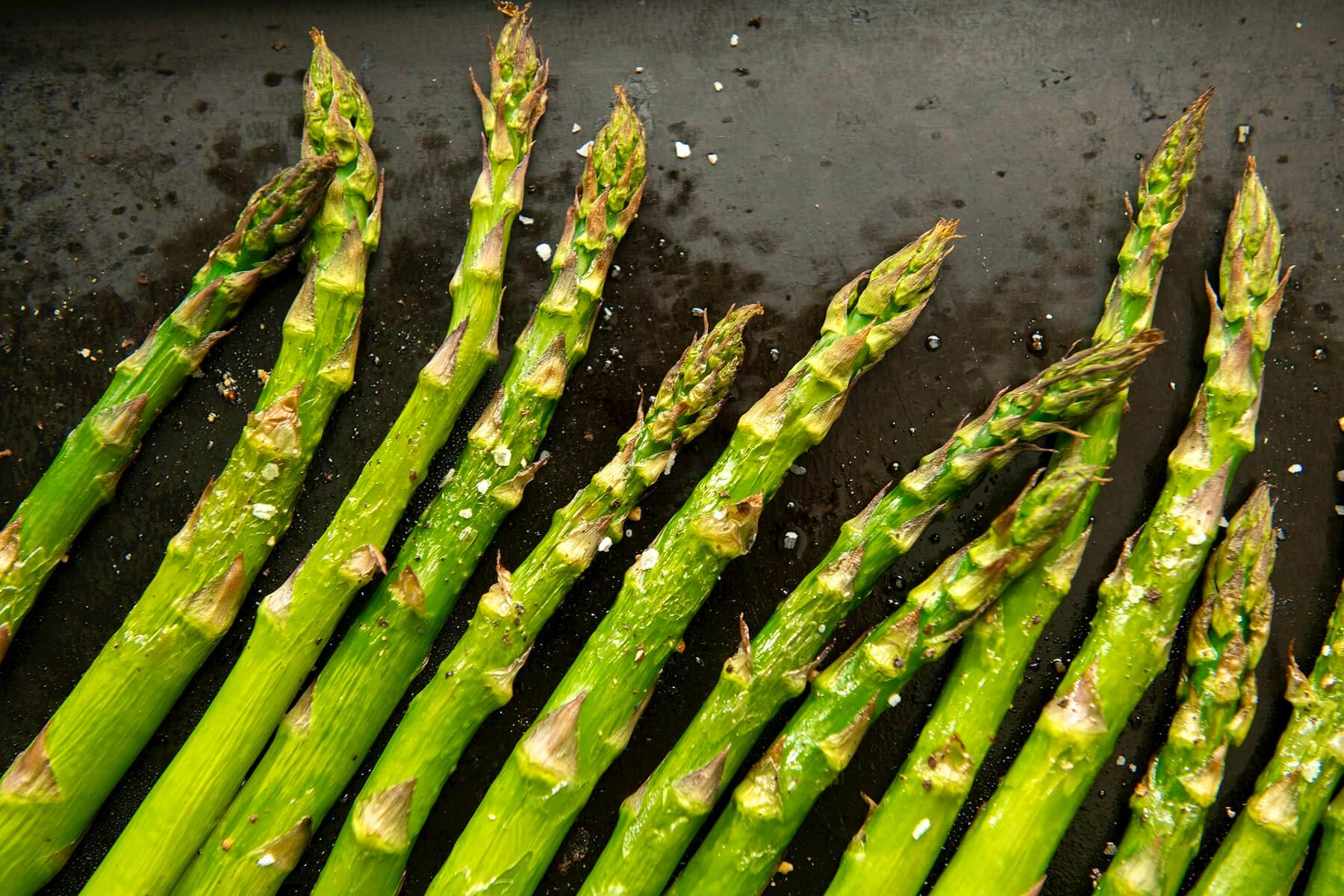 Asiago cheese provides a delightful alternative to Parmesan, adding a unique twist to simply roasted asparagus. The flavor of this side dishes belies its ease. Lemon slices make a pretty garnish.