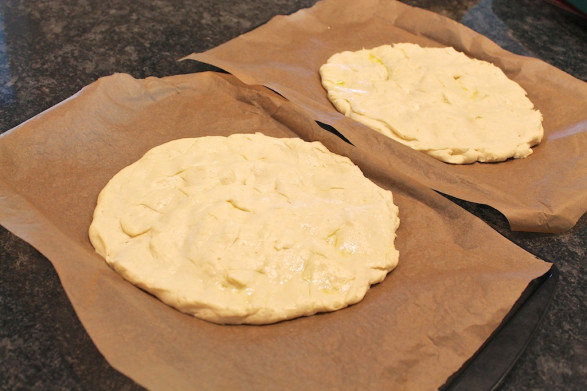 In this photo, the pizza crusts are spread to a 10-inch diameter. It works, but spreading to the 12-inch round or 10x15-inch dimension yields a crisper crust that my prefers.