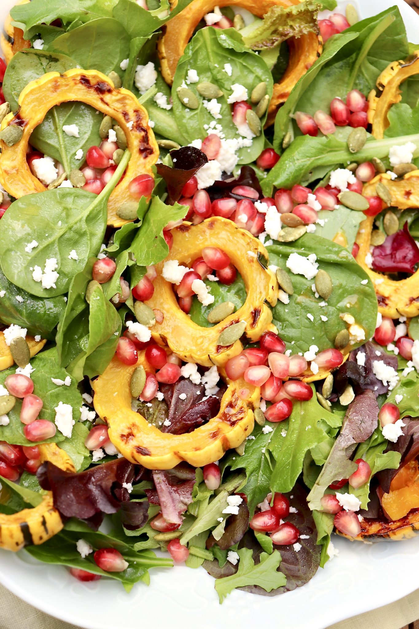 Radiant jewel tones make this versatile salad stunning AND healthy. Feel free to substitute any winter squash (even sweet potatoes) or use cranberries in place of pomegranate!