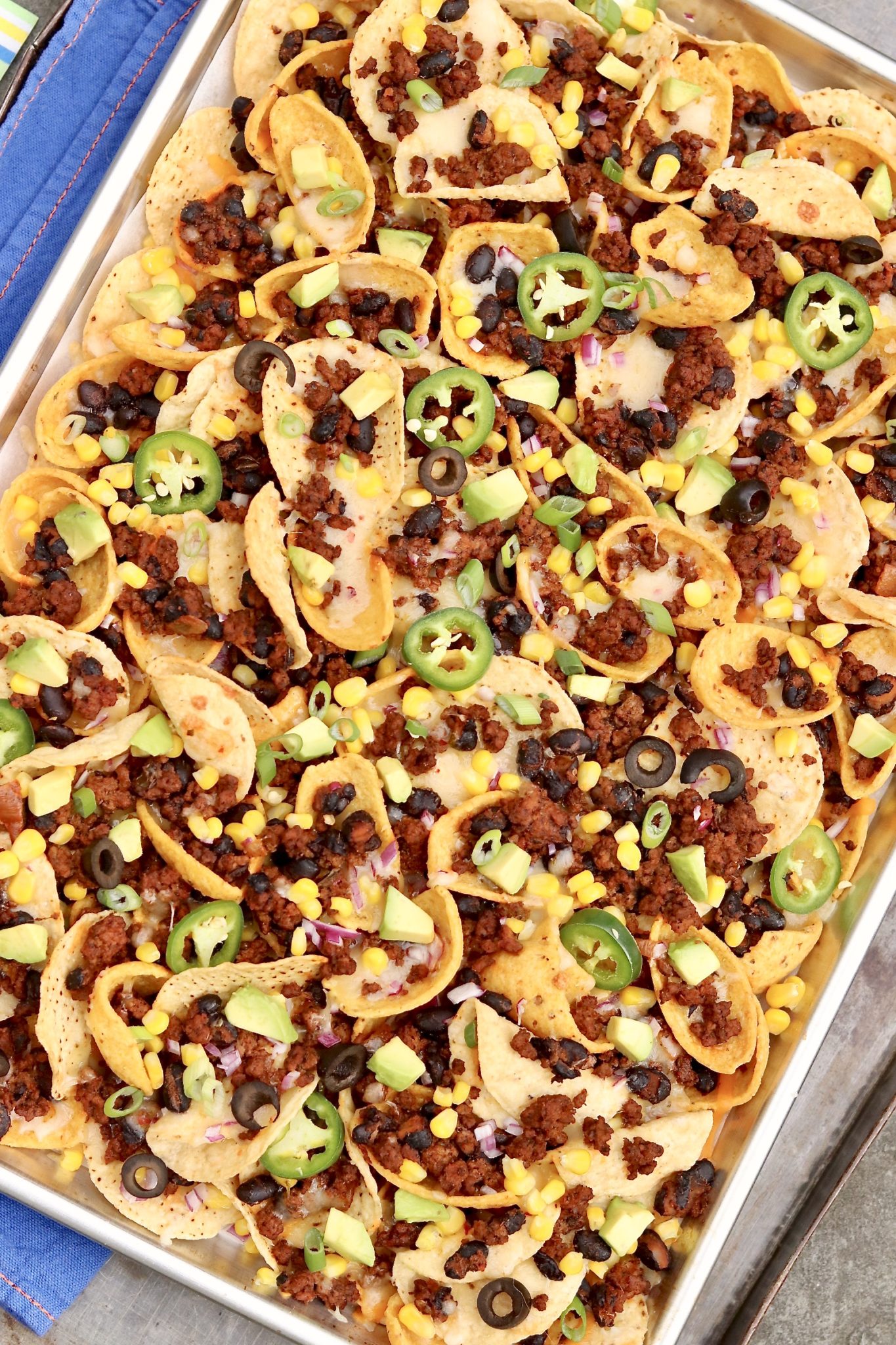 Super Bowl Nachos are the gold standard of nachos and include two types of chips for maximum crunch. Loaded with flavorful toppings (with a hint of health appeal), these nachos are game day perfection and hearty enough to be an occasional meal!