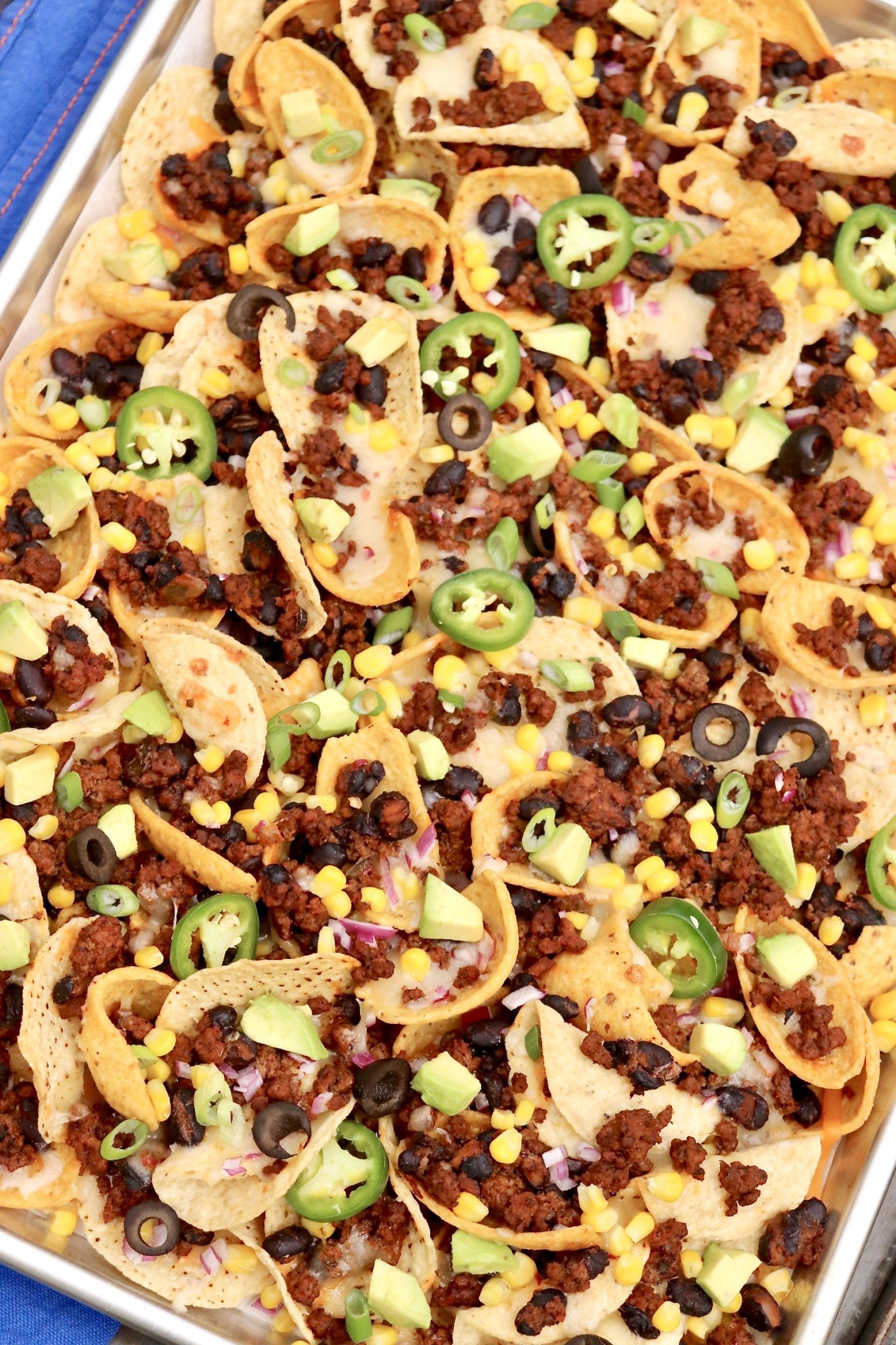 Super Bowl Nachos are the gold standard of nachos and include two types of chips for maximum crunch. Loaded with flavorful toppings (with a hint of health appeal), these nachos are game day perfection and hearty enough to be an occasional meal!