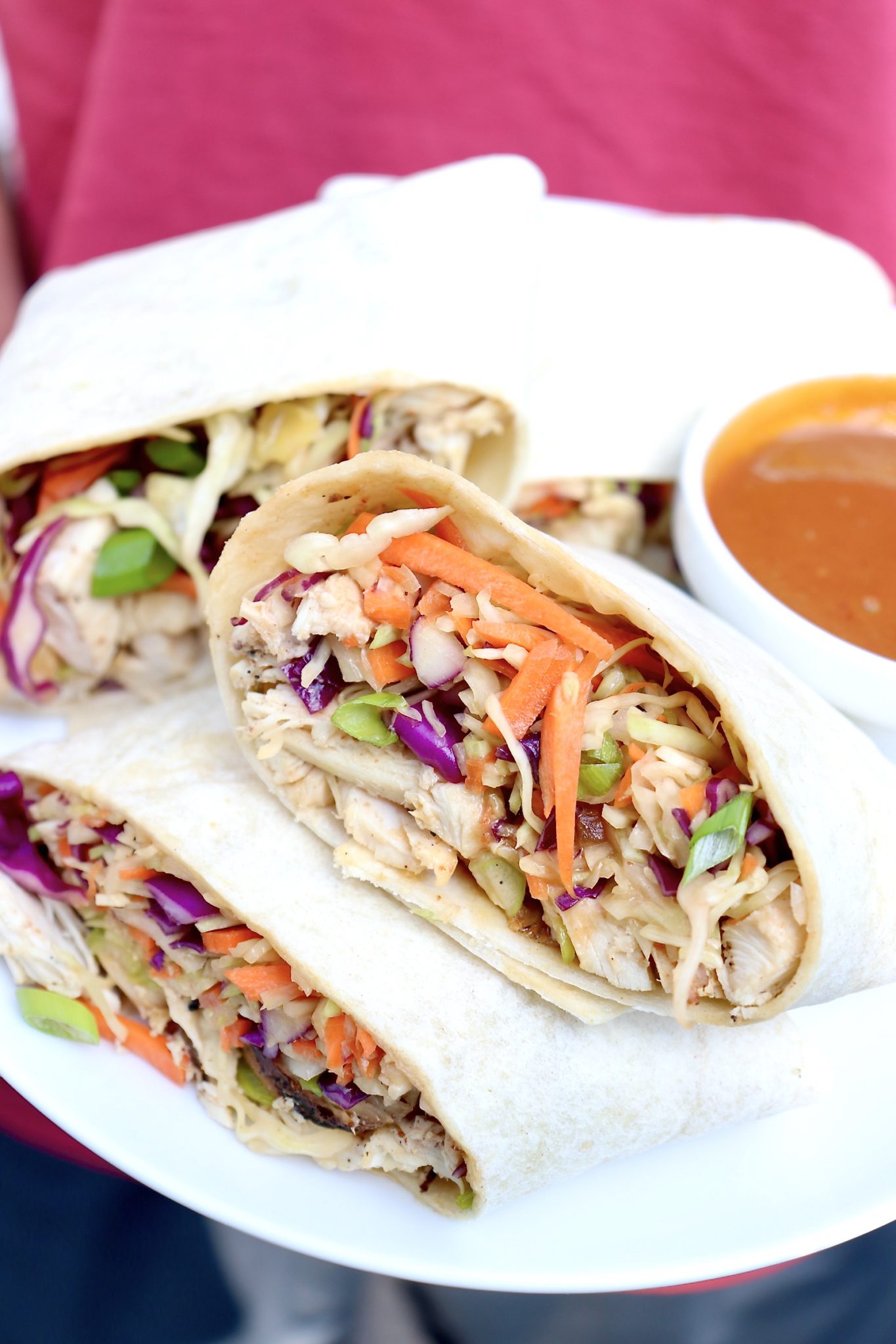 Crunchy slaw and protein-rich chicken are bathed in a peanutty dressing then rolled into a handy wrap in this Asian-inspired meal that is sure to become a family favorite!