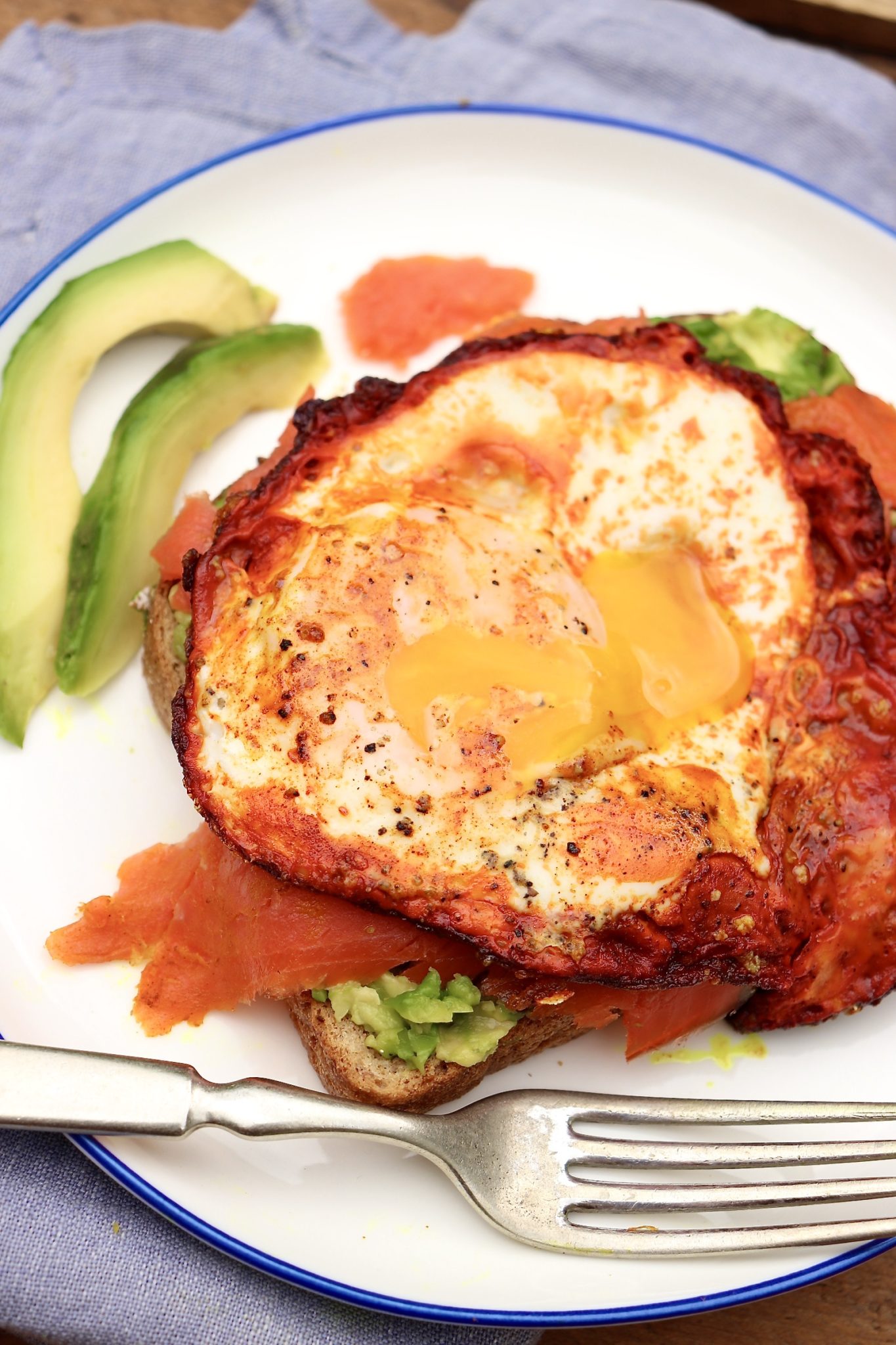 A crispy, turmeric-infused egg and a layer of Omega-3 rich salmon take the beloved avocado toast to soaring new heights!