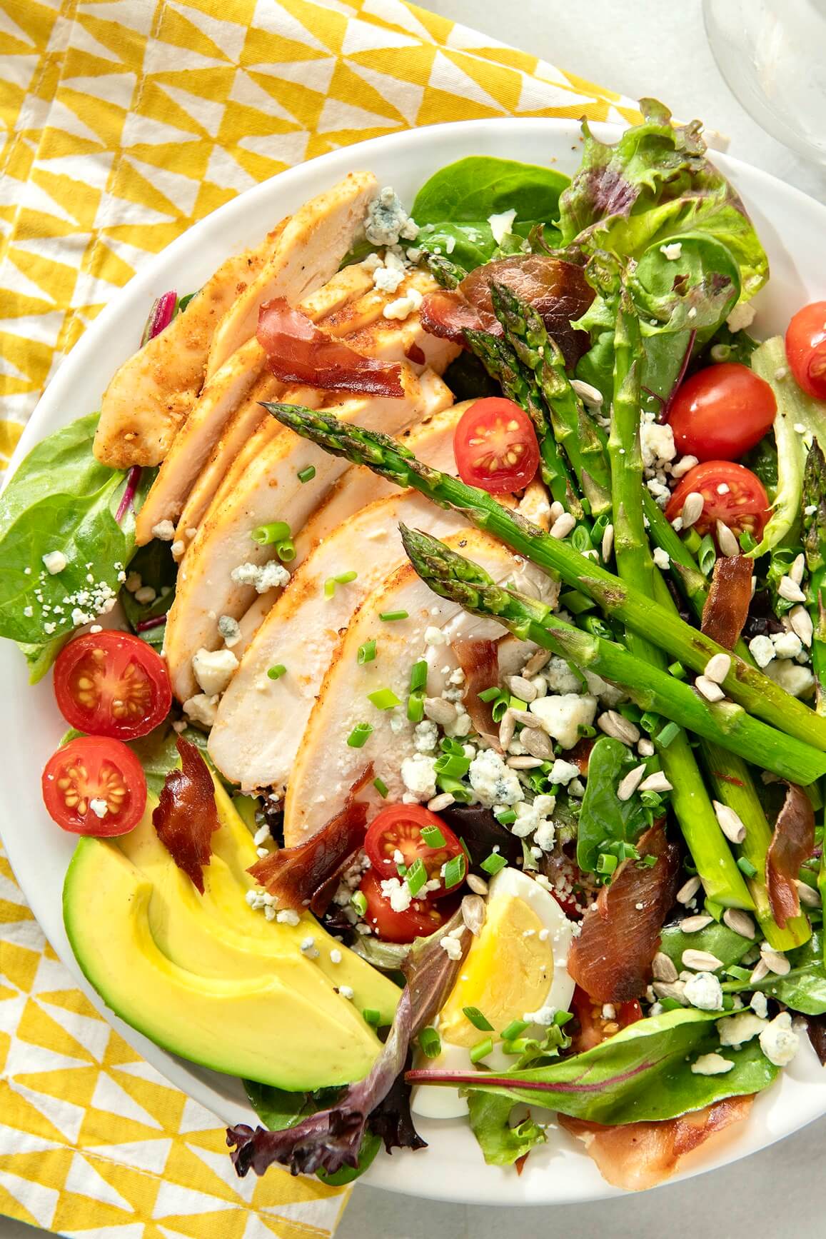 Sure, you can make a regular Cobb salad, and it will taste great. But adding asparagus ramps up the color, nutritional value, and seasonal appeal. If you don’t usually have salads for dinner, this satisfying plateful might win you over. (Bonus recipes included!)