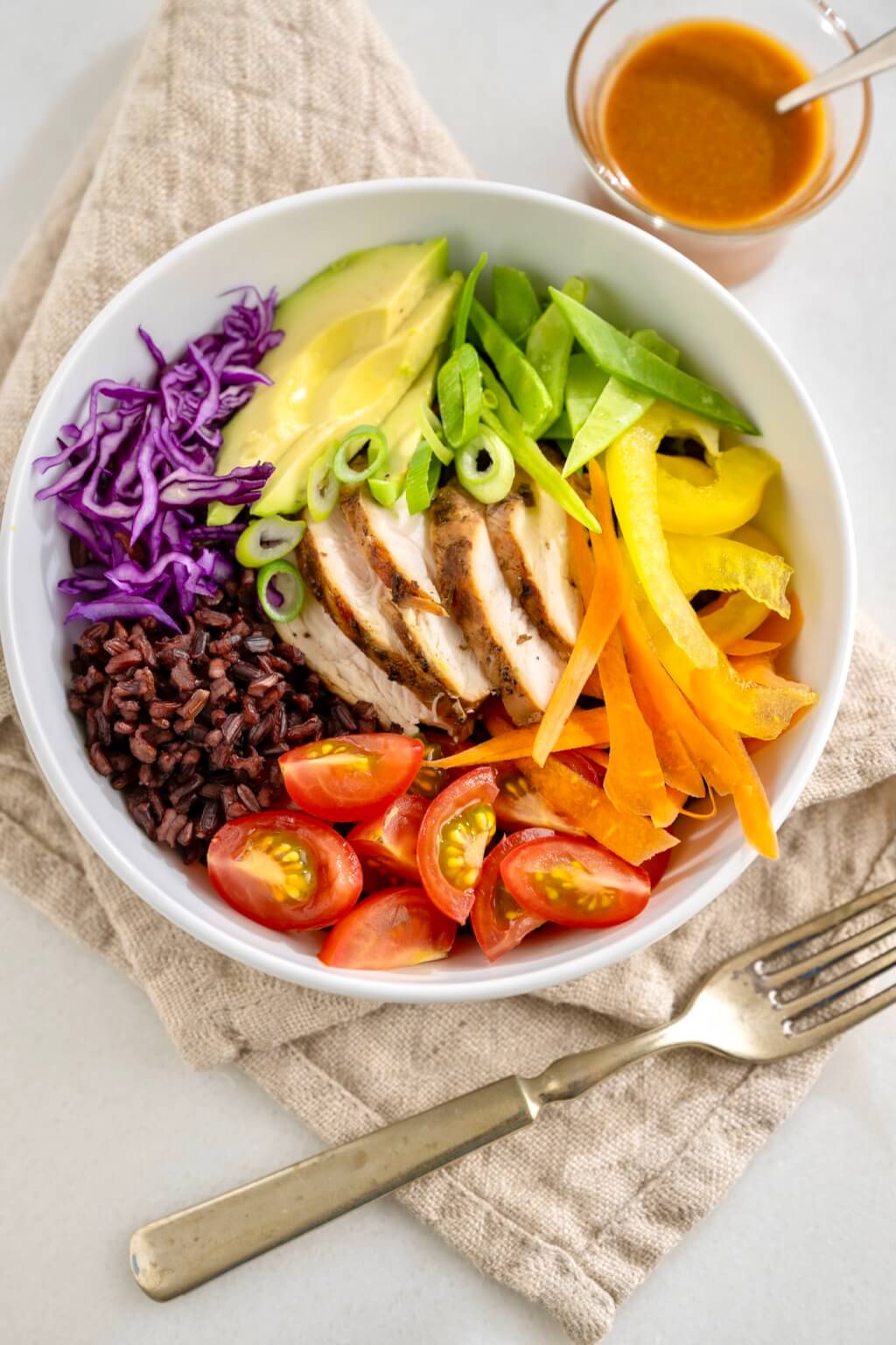 A literal rainbow of fresh produce adds colorful crunch and visual appeal to these flexible rice-based bowls. The flavor-popping peanut sauce is easy to make and endlessly versatile--the proverbial pot of gold!