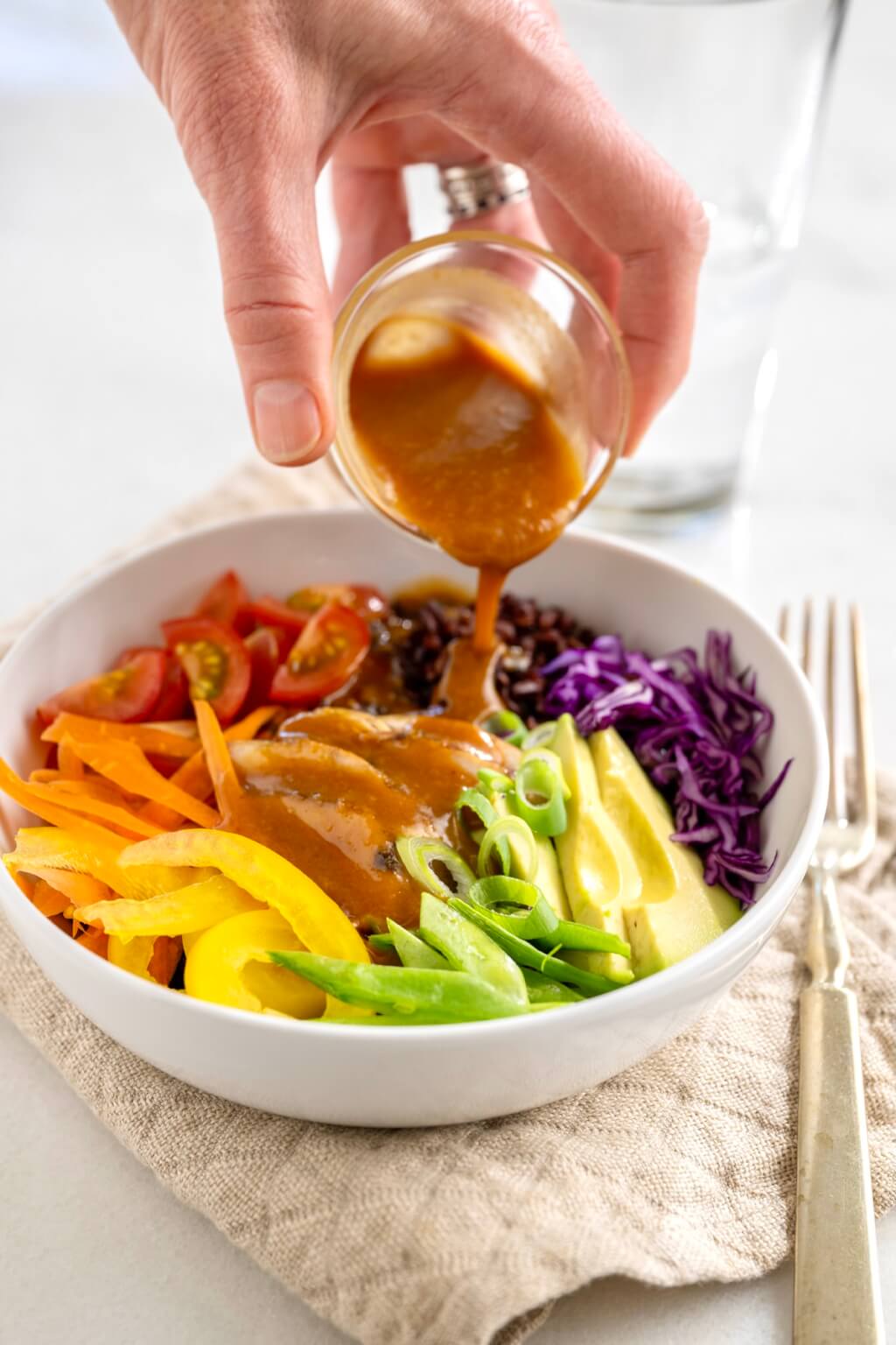 A literal rainbow of fresh produce adds colorful crunch and visual appeal to these flexible rice-based bowls. The flavor-popping peanut sauce is easy to make and endlessly versatile--the proverbial pot of gold!