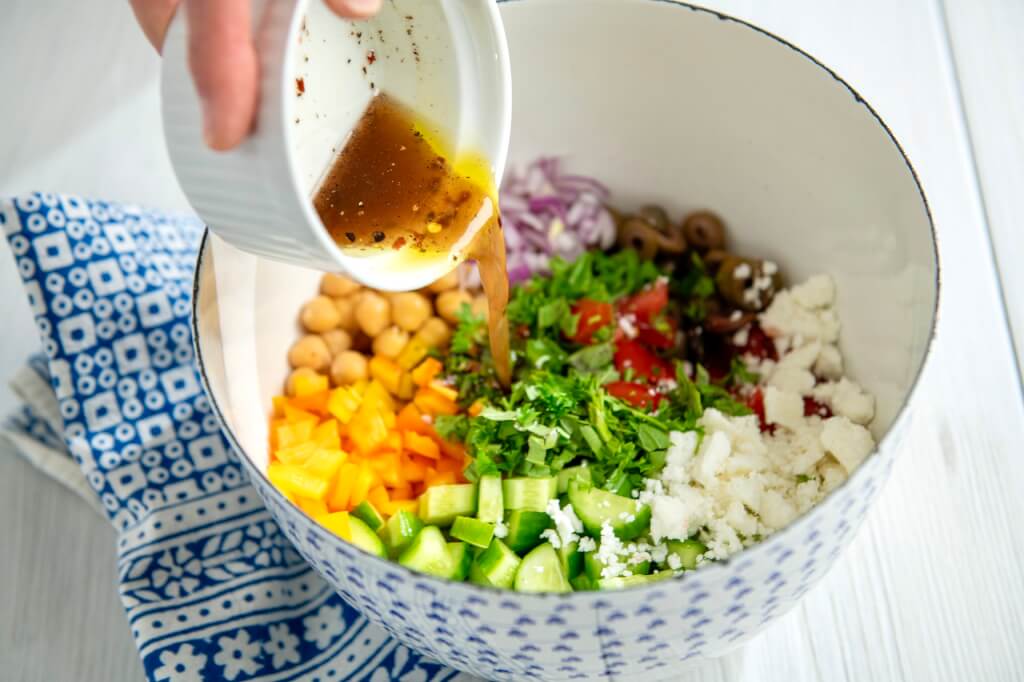 An economical can of beans mixes with fresh veggies and a flavorful vinaigrette in this versatile, plant-based salad that can be adapted in countless ways.