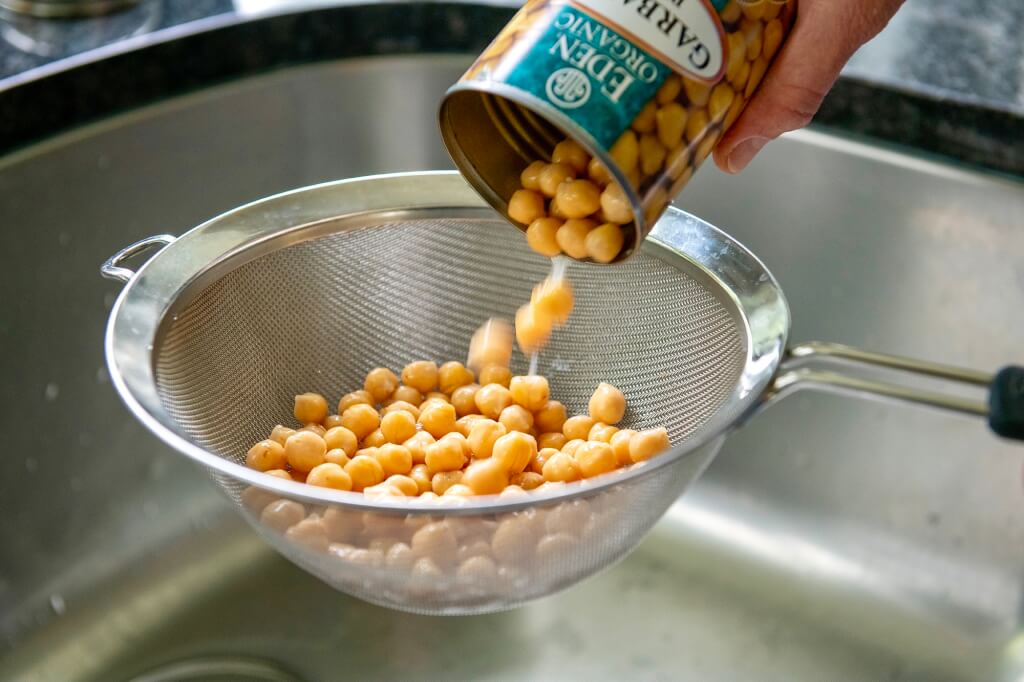 An economical can of beans mixes with fresh veggies and a flavorful vinaigrette in this versatile, plant-based salad that can be adapted in countless ways.