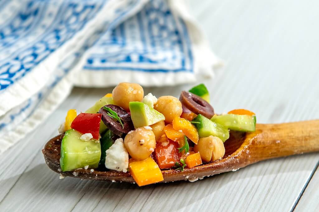 An economical can of beans mixes with fresh veggies and a flavorful vinaigrette in this versatile, plant-based salad that can be adapted in countless ways.