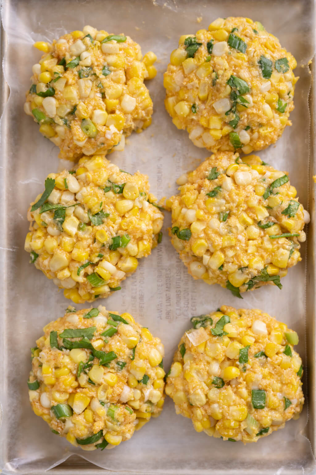 Golden corn fritters are a deliciously easy way to repurpose leftover corn and there's no need to deep fry. The simple sauce is optional but takes the fritters to the next level. Entertaining? Make appetizer-size fritters!