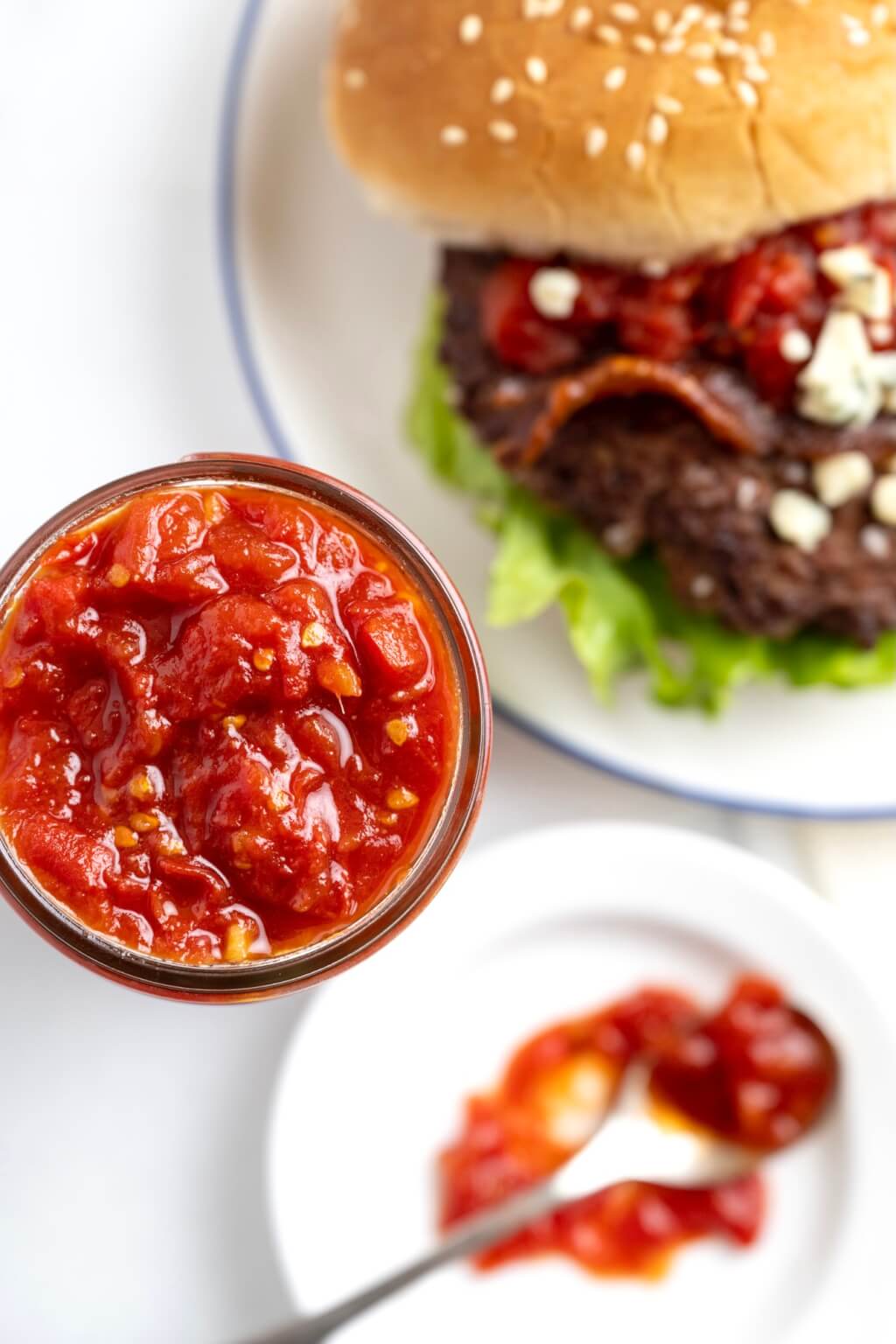 Easy-to-make tomato jam is savory and tangy with a hint of spicy sweetness. An ideal way to use a bumper crop of tomatoes, the rustic jam is a delightful alternative to ketchup on a burger or chutney on grilled chicken, fish, or pork.