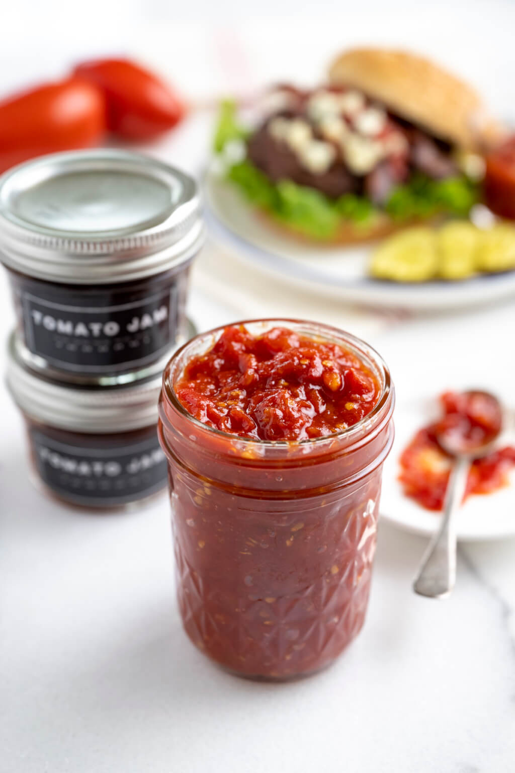 Easy-to-make tomato jam is savory and tangy with a hint of spicy sweetness. An ideal way to use a bumper crop of tomatoes, the rustic jam is a delightful alternative to ketchup on a burger or chutney on grilled chicken, fish, or pork.